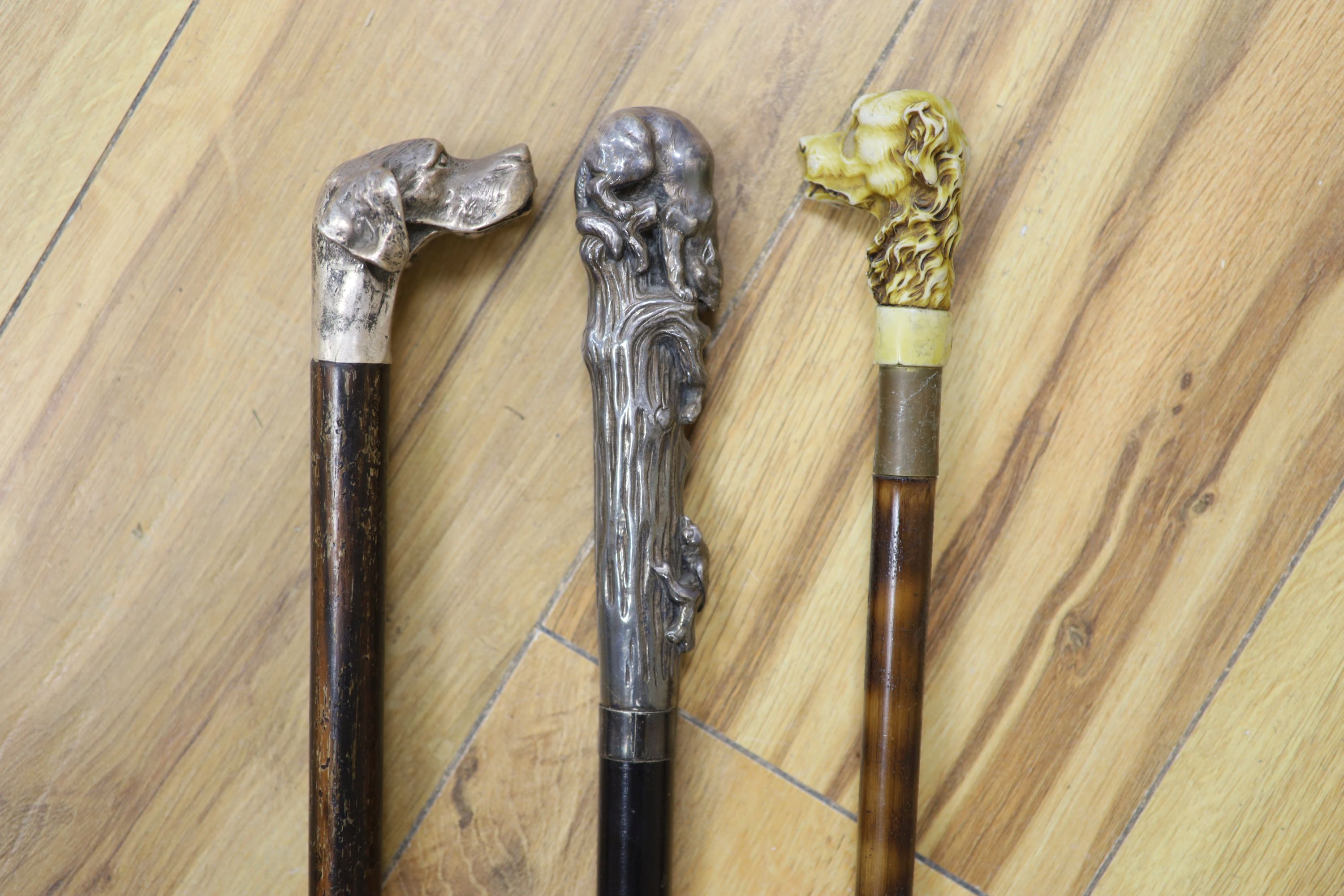 A big cat sterling-mounted cane, a dogs head 925 sterling mounted cane and a resin dogs head mounted cane